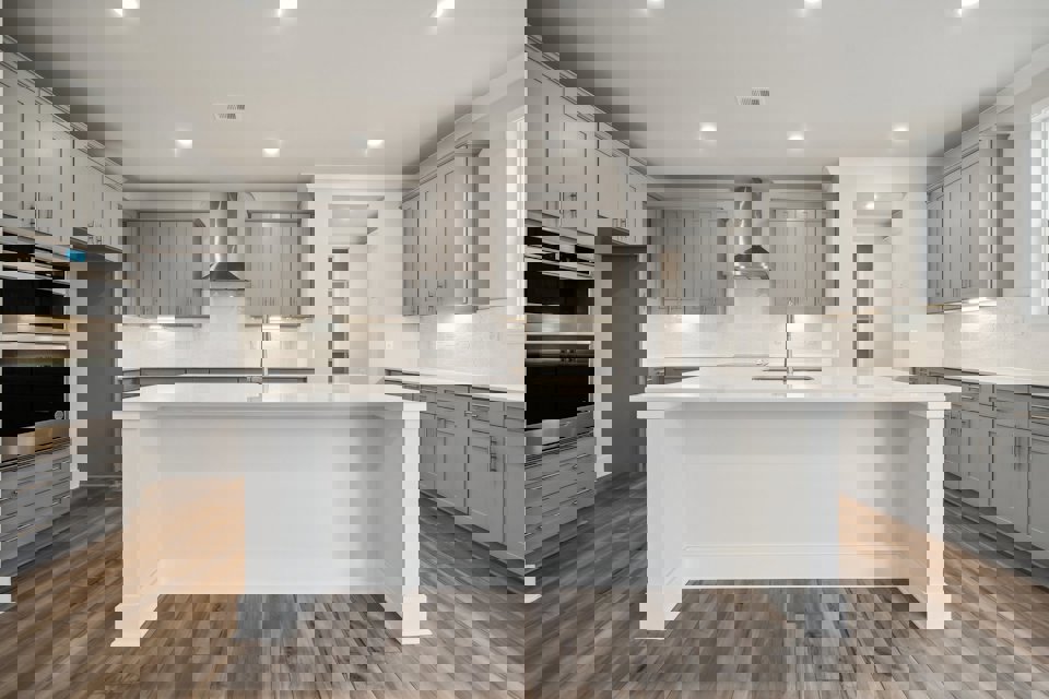 A kitchen with white cabinets.