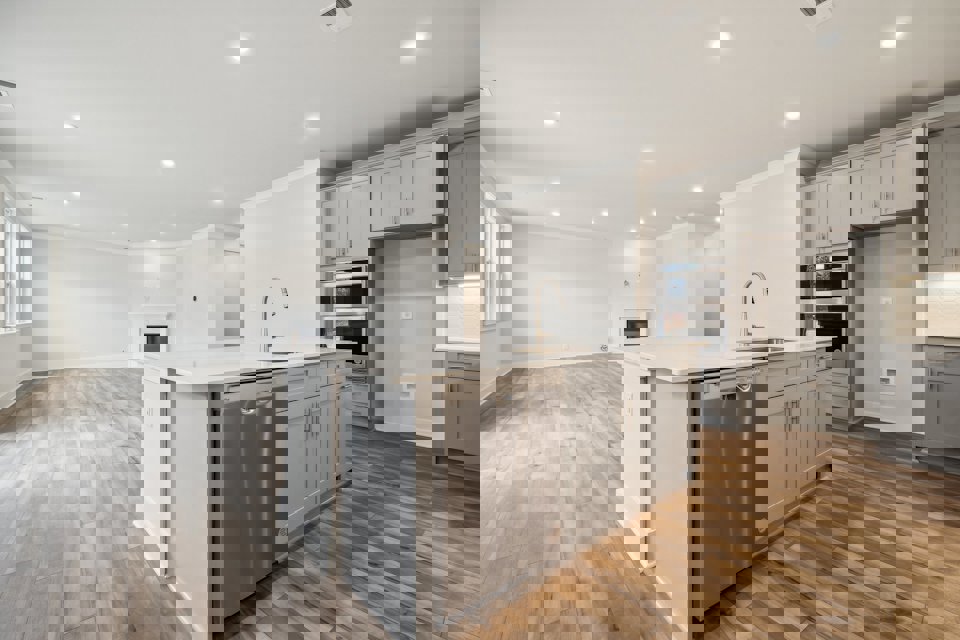 A kitchen with white cabinets.