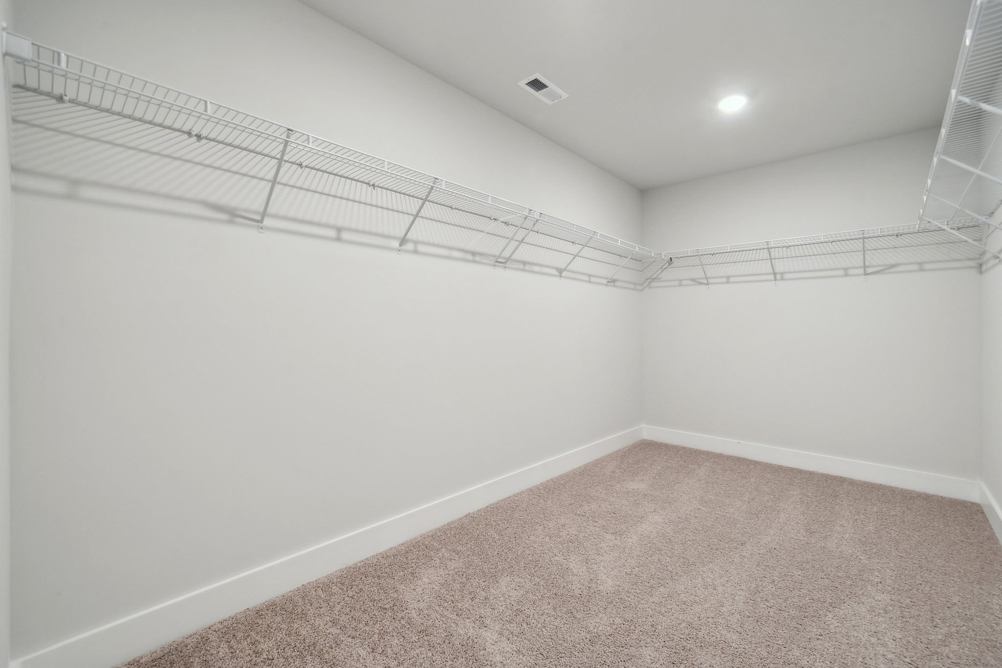 A white room with a carpet.