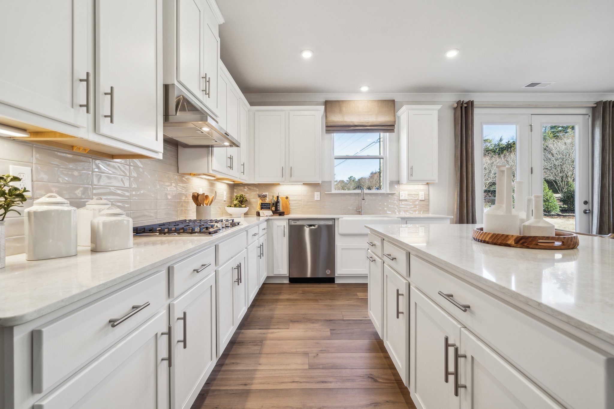 A kitchen with white cabinets.