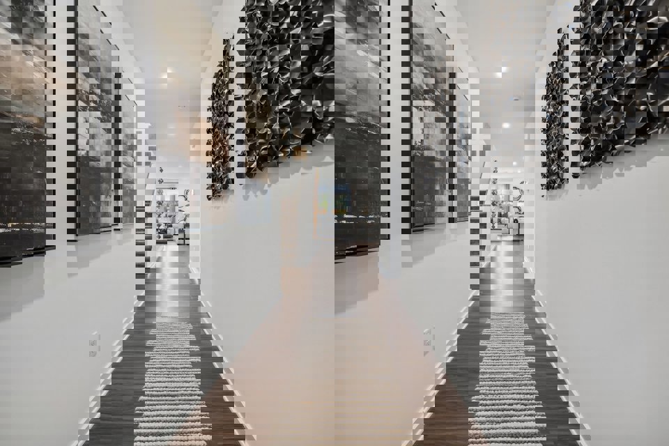 A hallway with art on the walls.