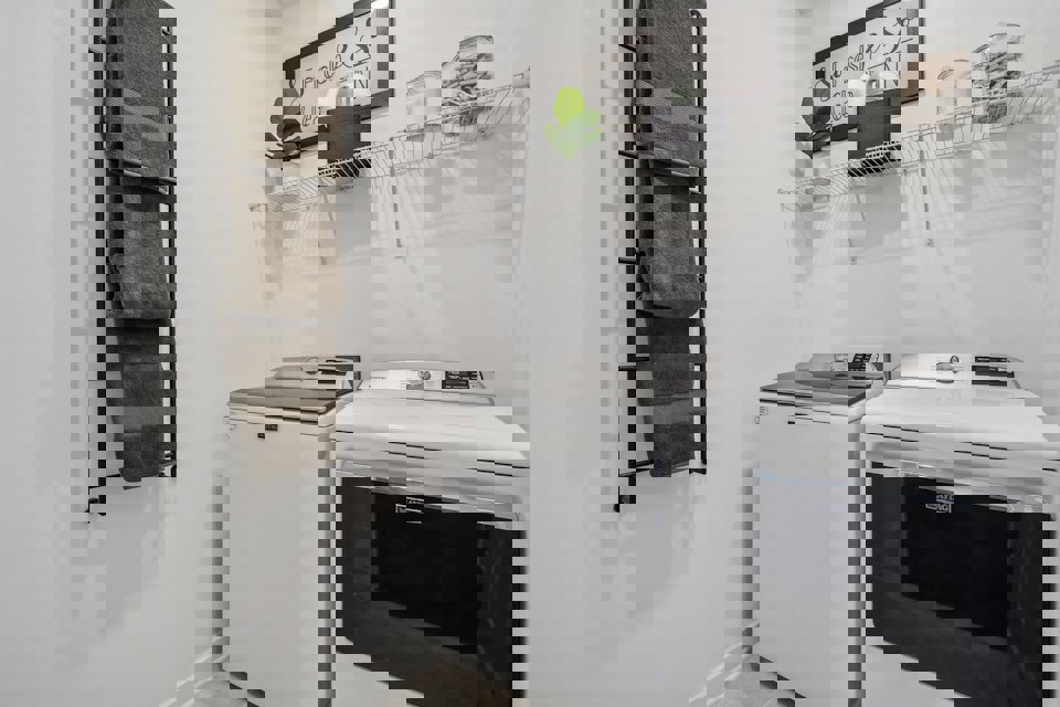 A kitchen with a washer and dryer.