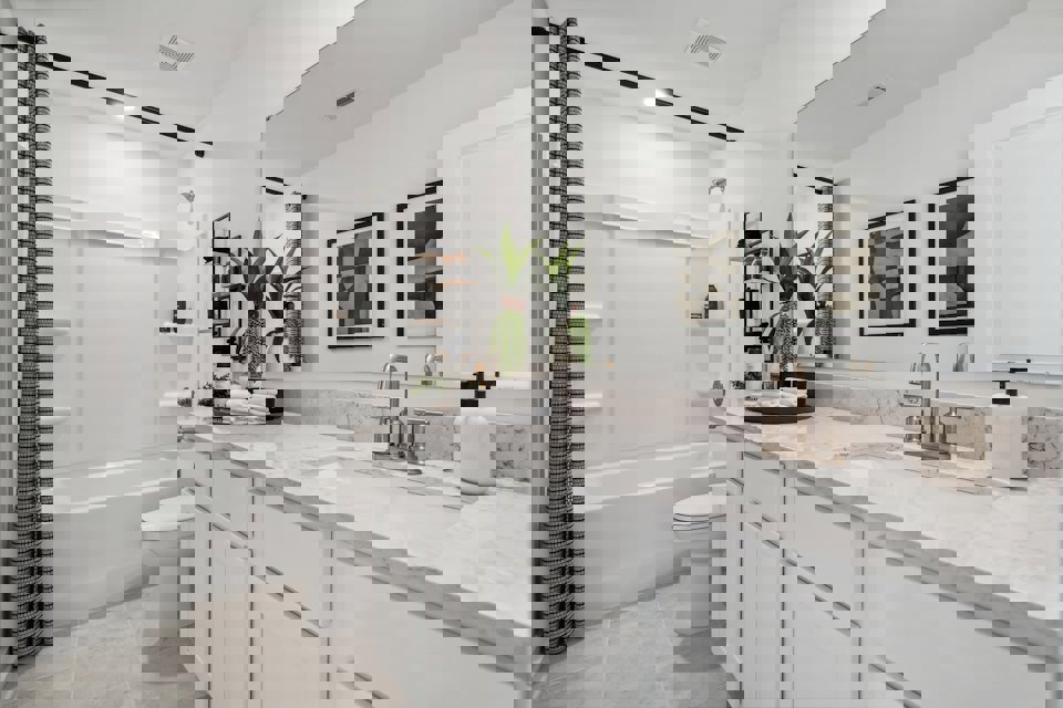 A bathroom with a tub sink and toilet.