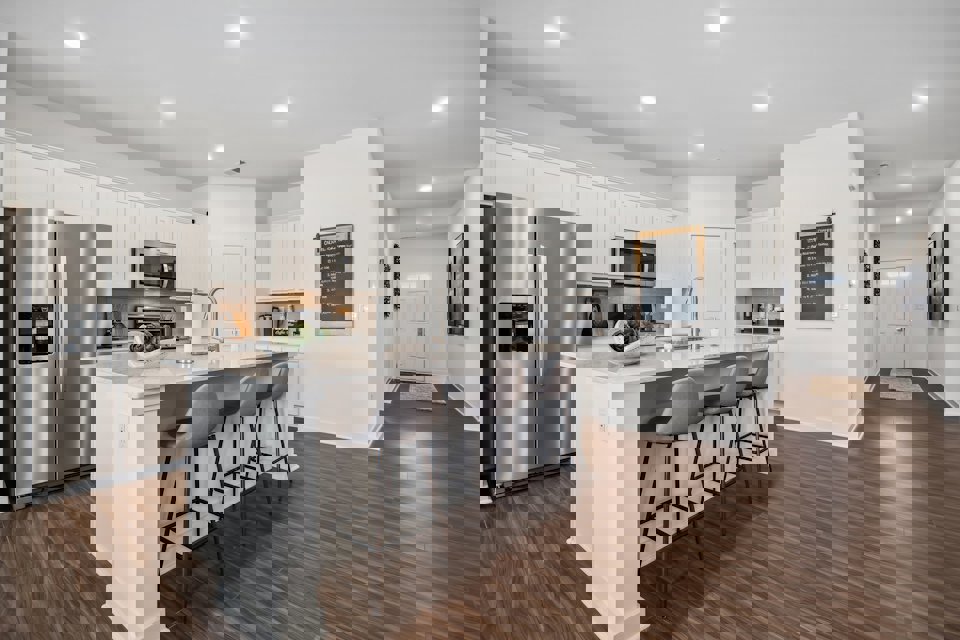 A kitchen with white cabinets.