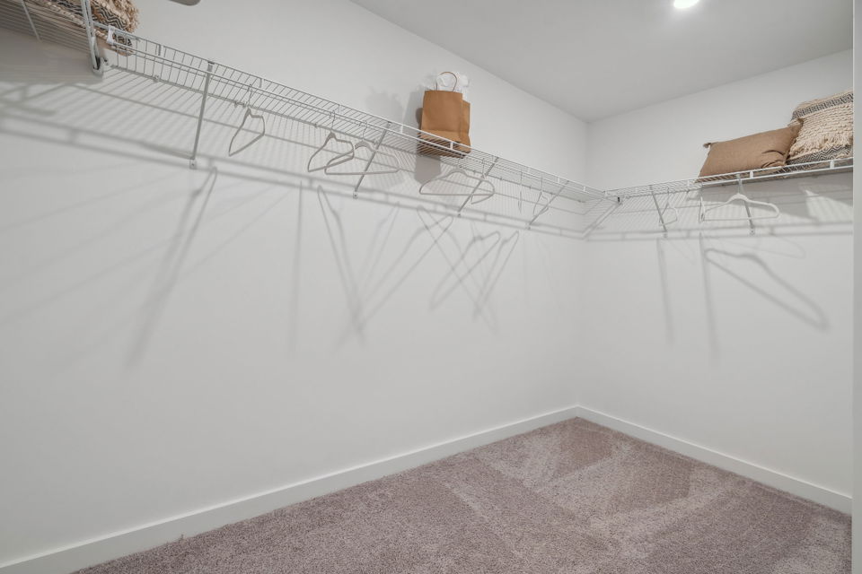 A white bed with a white sheet.