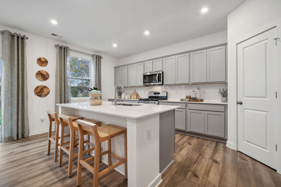 A kitchen with white cabinets.