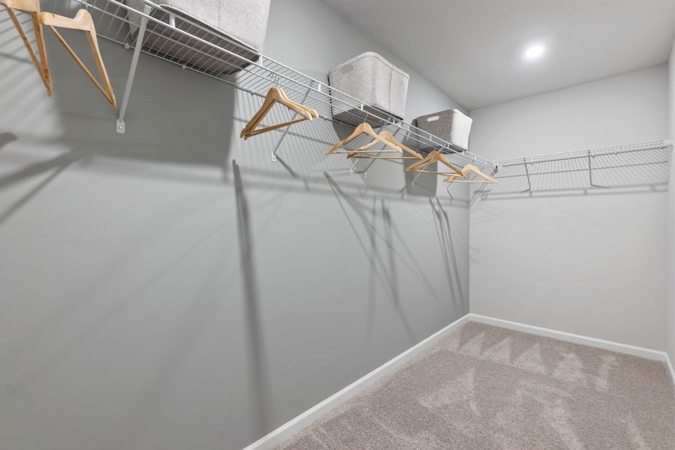 A white room with a white wall and a metal railing.