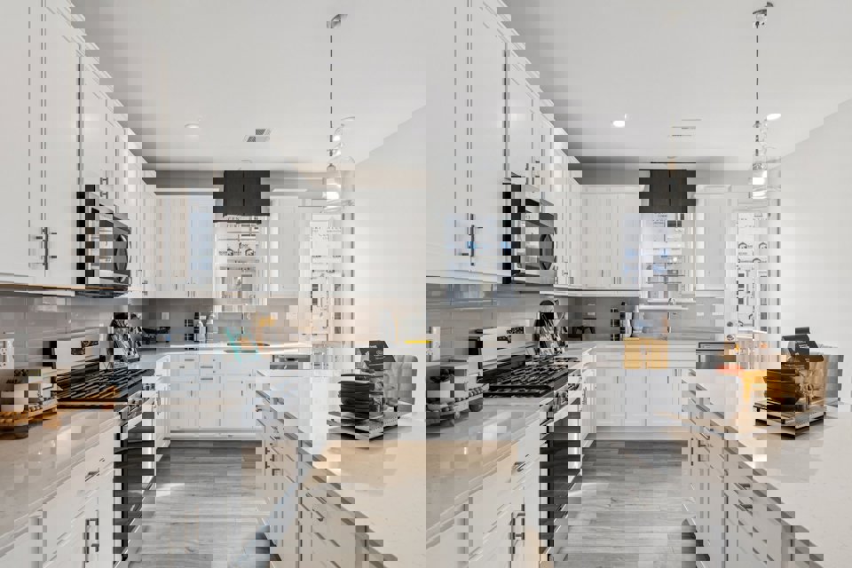 A kitchen with white cabinets.