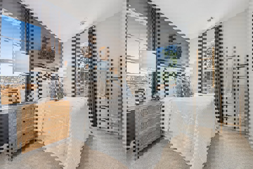 A bedroom with a bed and a window.