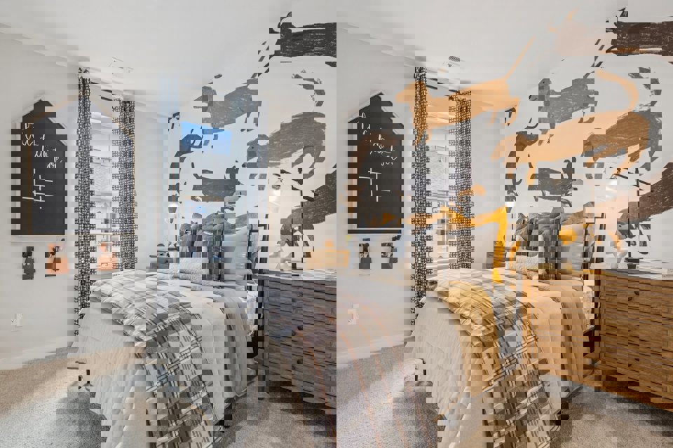 A bedroom with a large bed and a large poster on the wall.