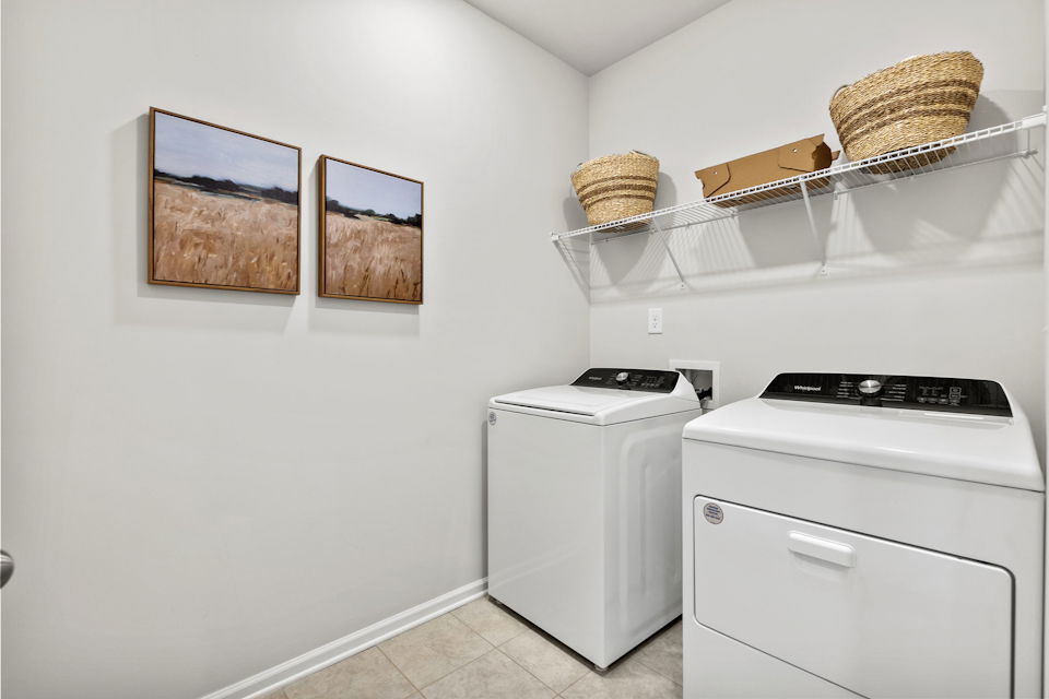 A kitchen with a washer and dryer.