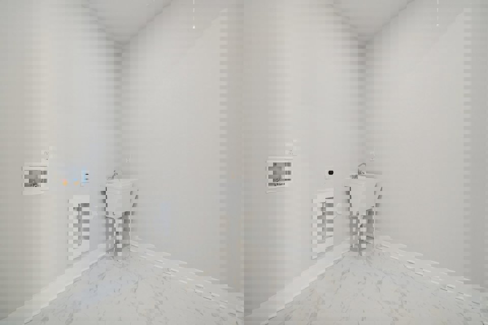 A white bathroom with a sink.