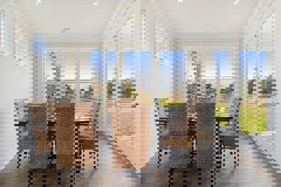 A dining room with a large window.