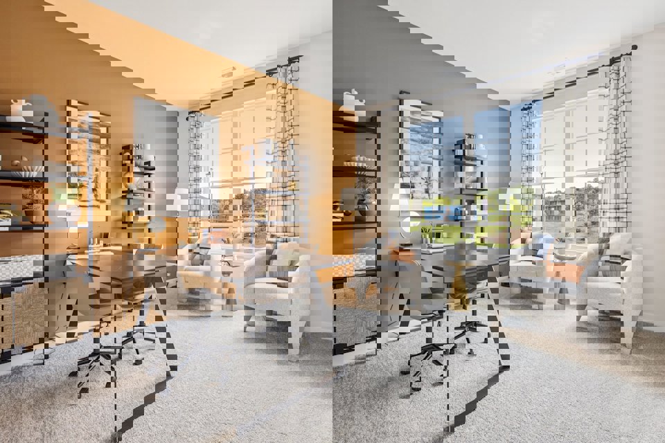 A room with a table chairs and a window.