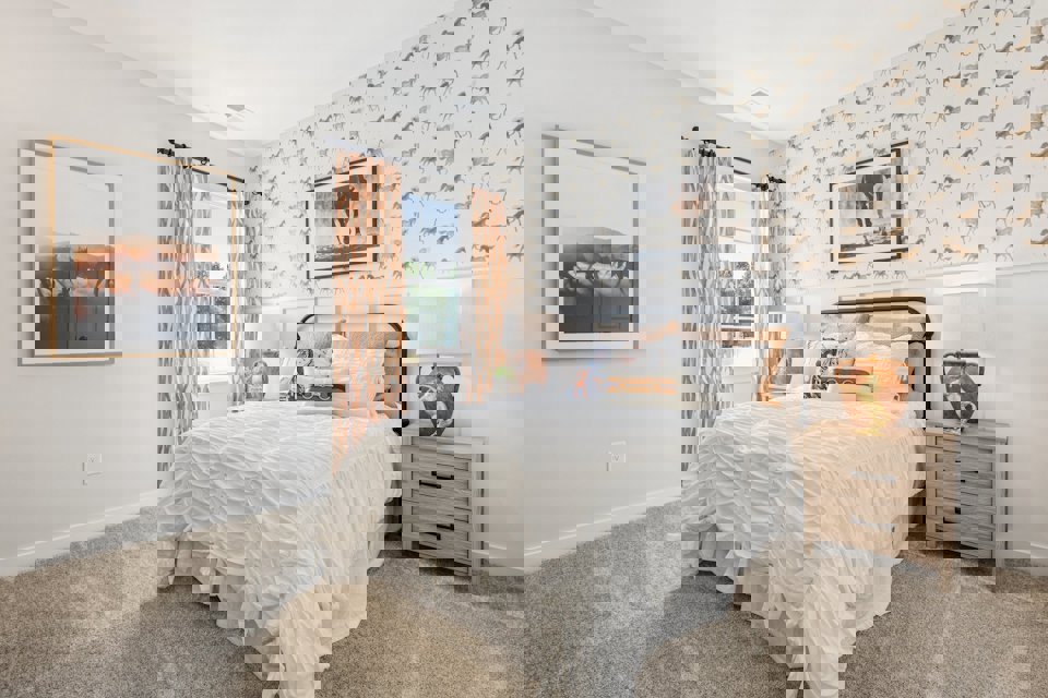 A bedroom with a bed and lamps.