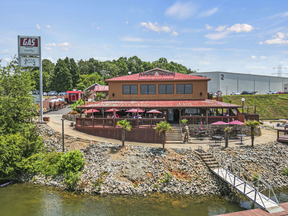 A building with a pond in front of it.