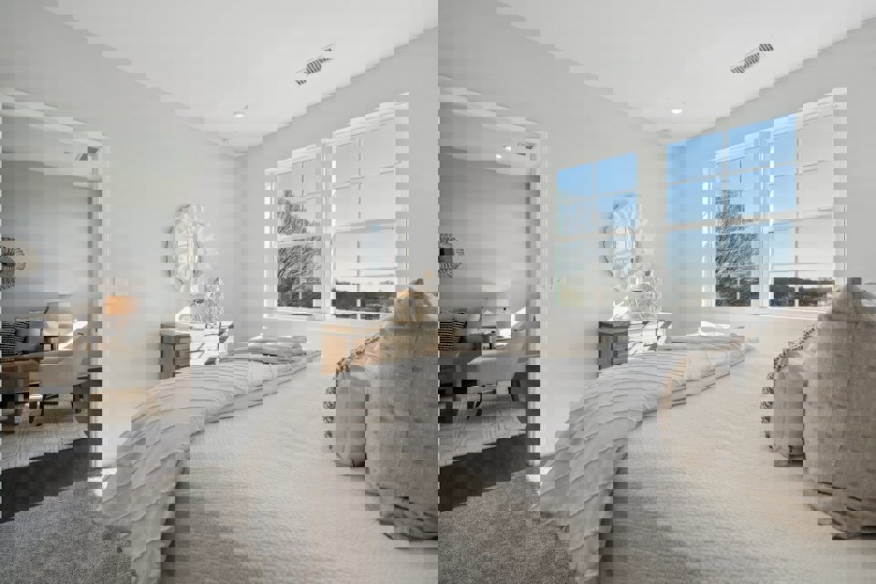 A bedroom with a bed and a mirror.