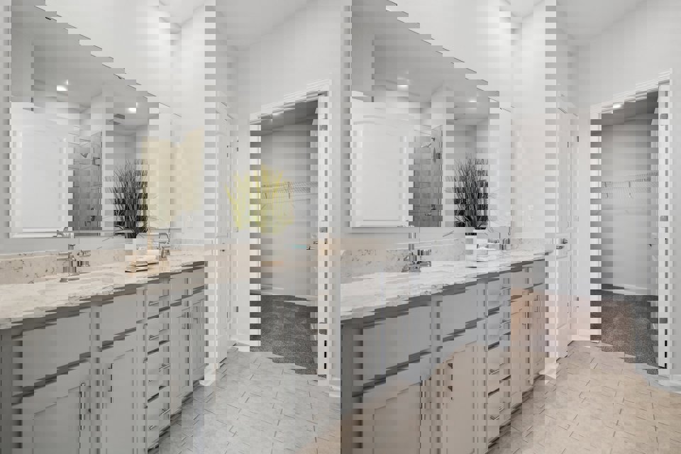 A bathroom with white cabinets.