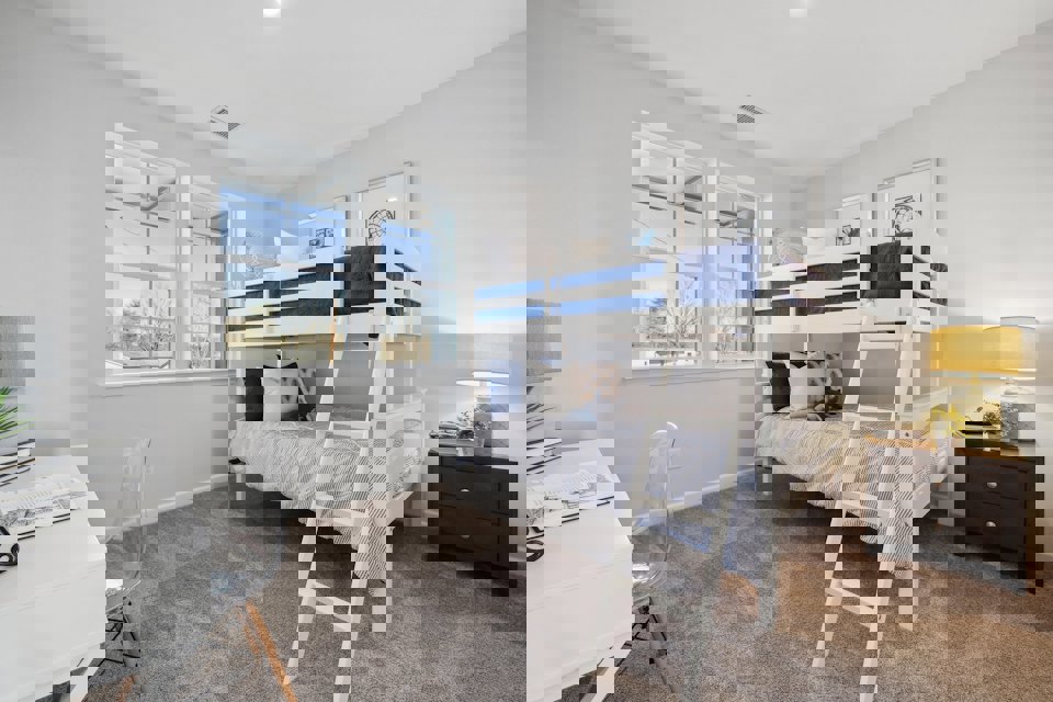 A room with a bed and a desk.