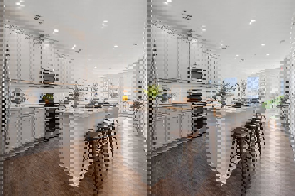 A kitchen with white cabinets.