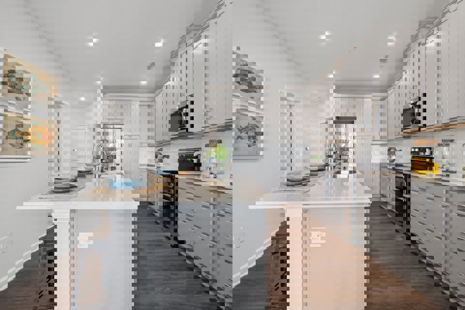 A kitchen with white cabinets.