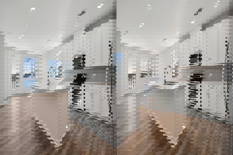 A kitchen with white cabinets.