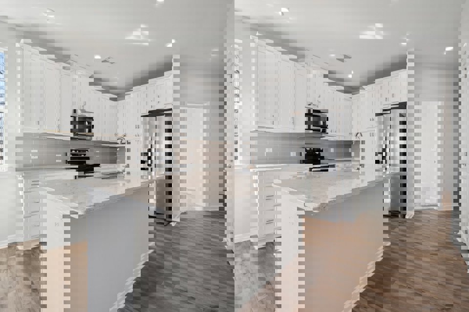 A kitchen with white cabinets.