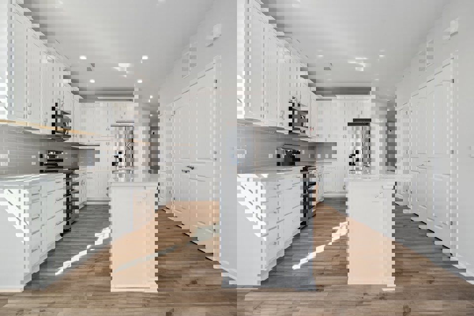 A kitchen with white cabinets.