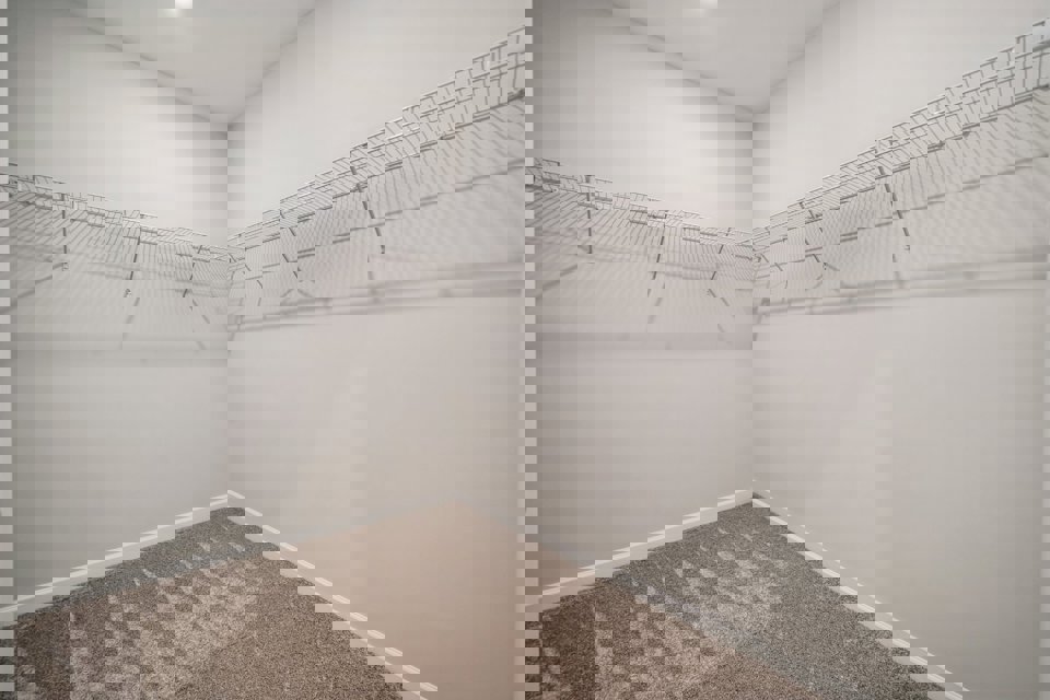 A white hallway with a tile floor.