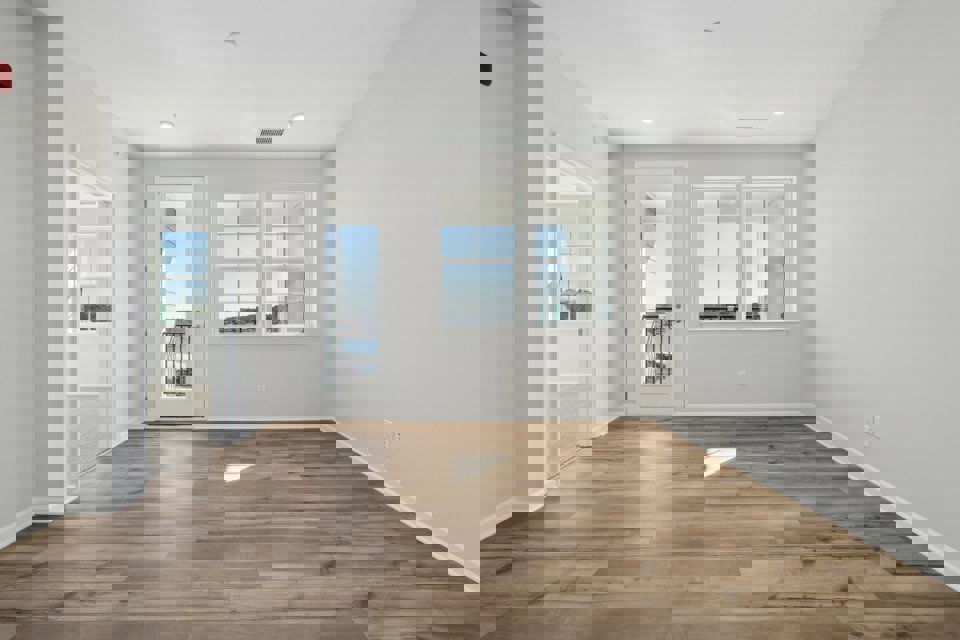 A room with white walls and a wood floor.