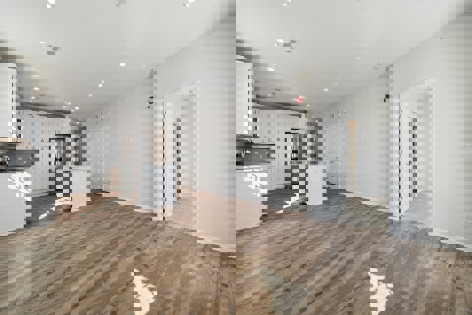 A large kitchen with white cabinets.