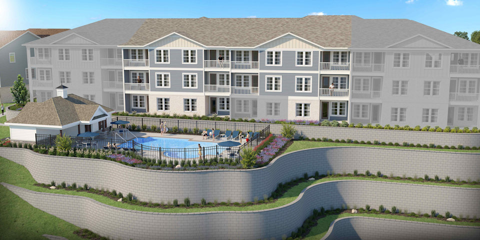 A large white building with a pool.