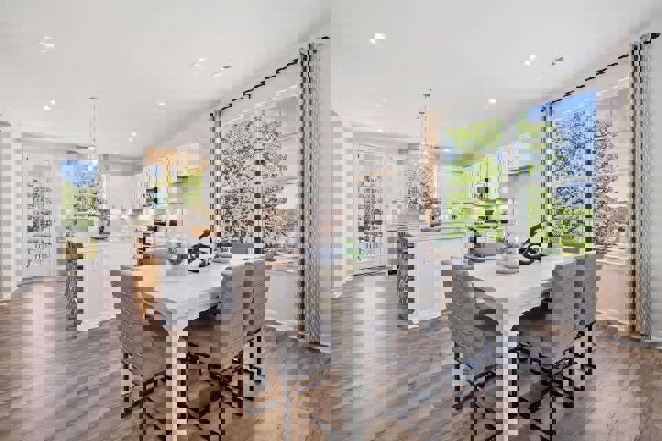 A kitchen with a dining table and chairs.