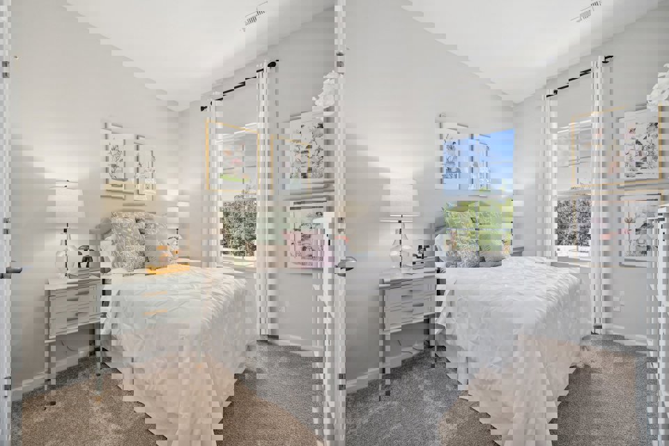 A bedroom with a bed and a window.