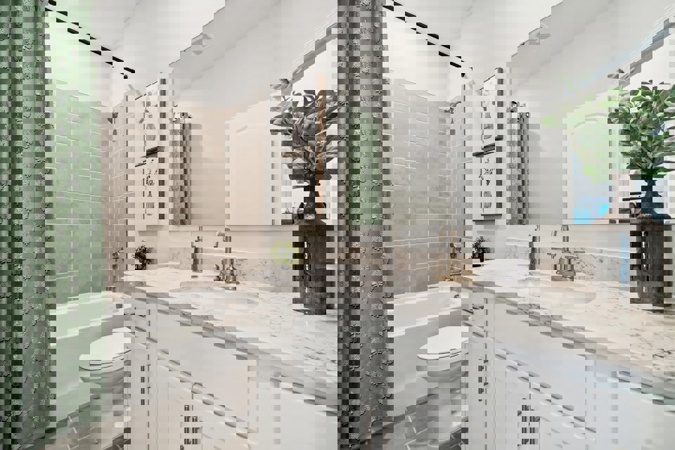 A bathroom with a sink toilet and a bathtub.