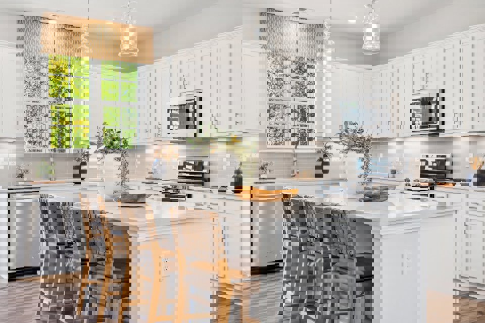 A kitchen with white cabinets.