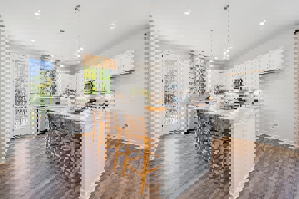 A kitchen with white cabinets.