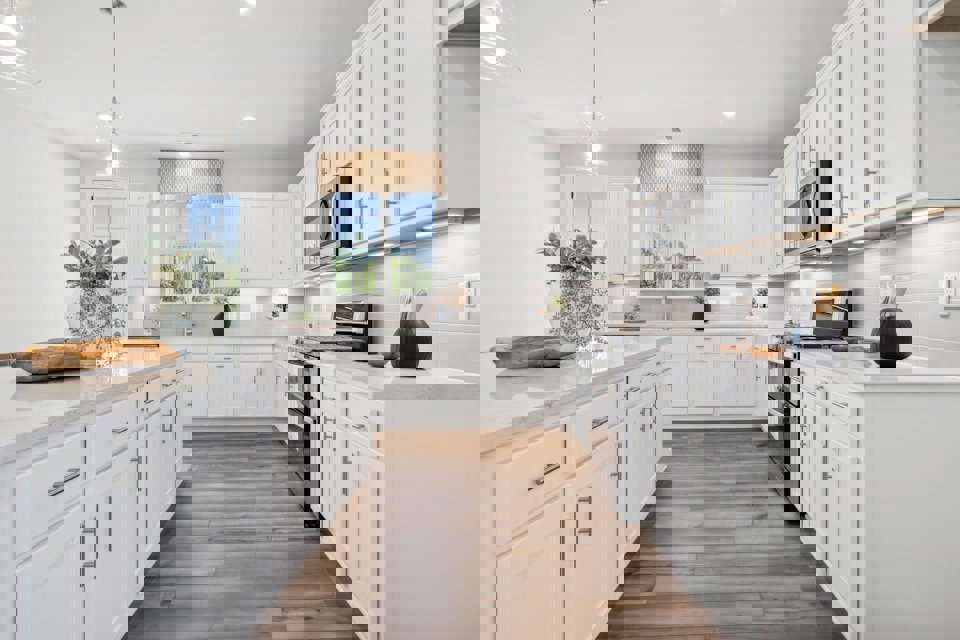 A kitchen with white cabinets.