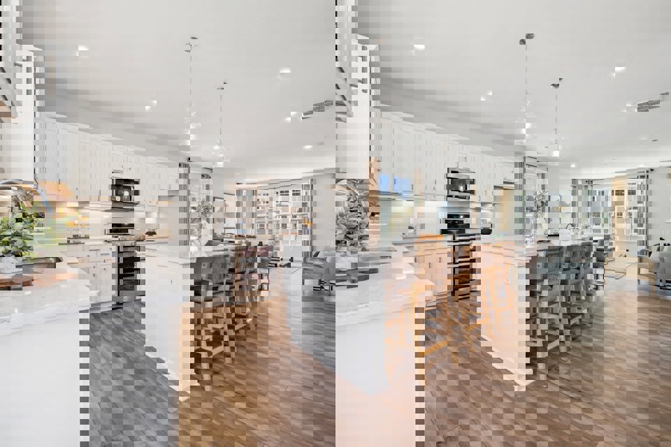 A kitchen with white cabinets.