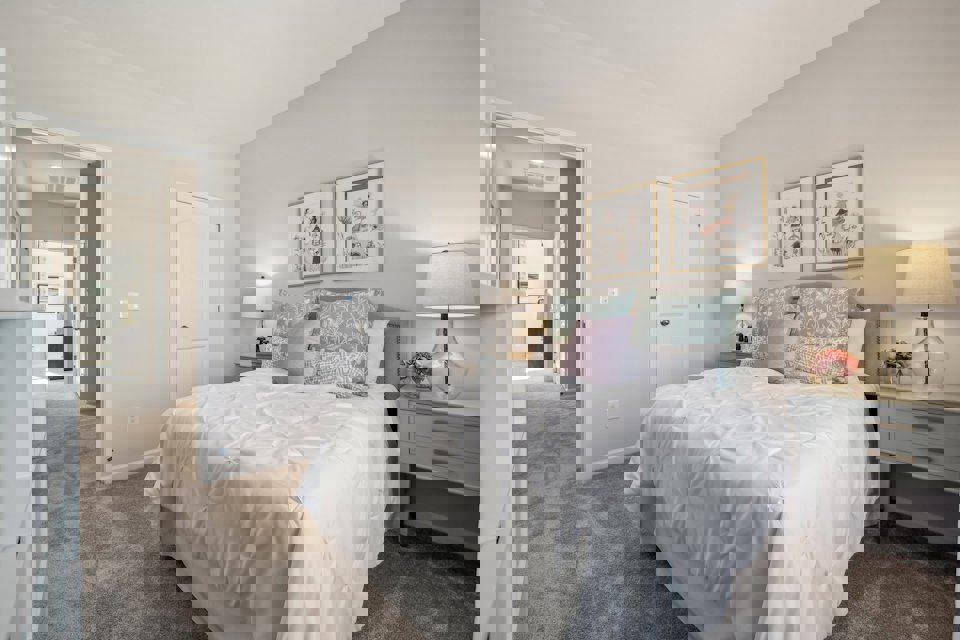 A bedroom with a bed and lamps.