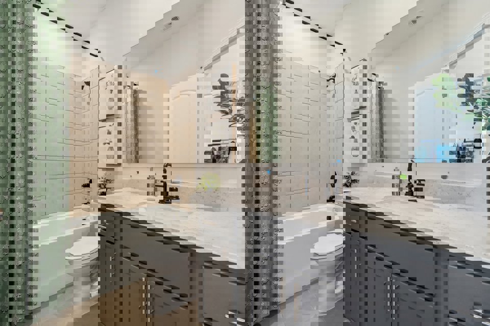 A bathroom with a tub sink and toilet.