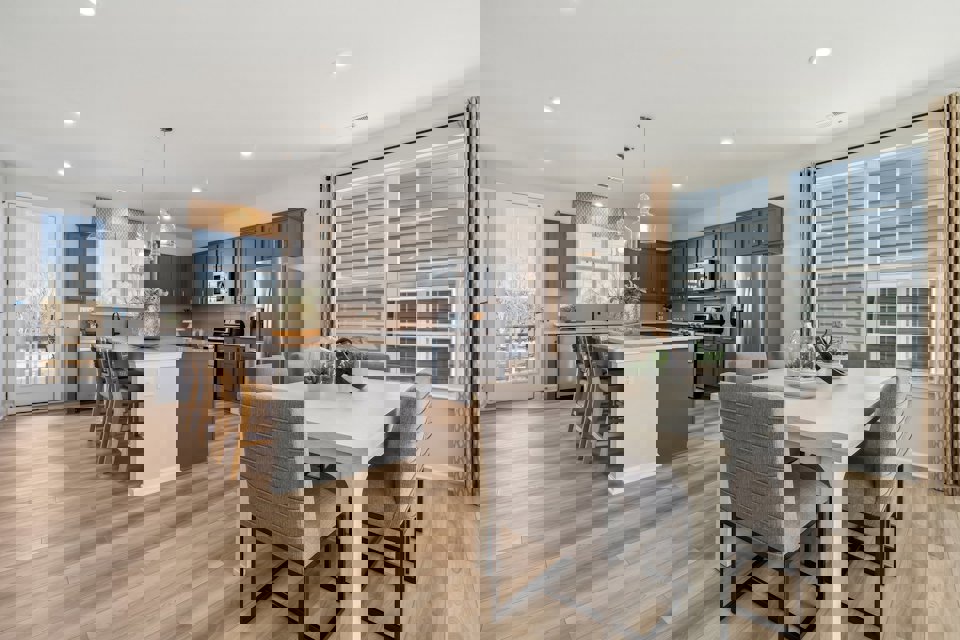 A large kitchen with a dining table.