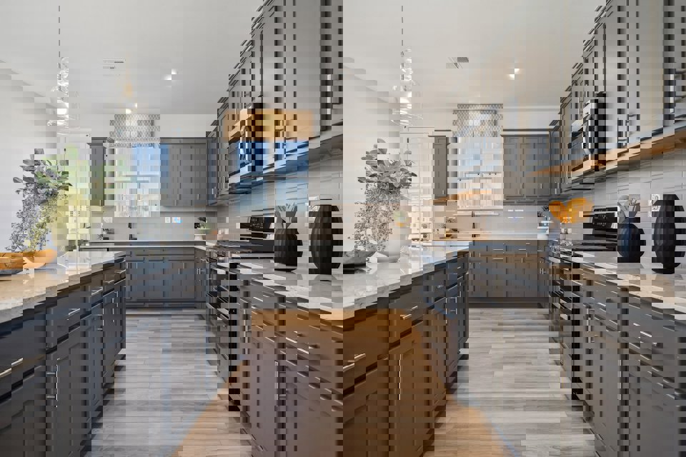 A kitchen with black cabinets.