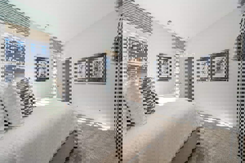 A bedroom with a bed and a lamp.