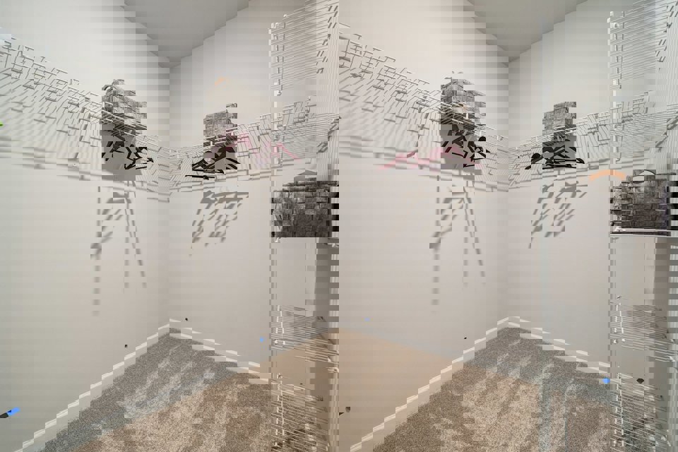 A room with a white wall with a white wall with a drawing on it.