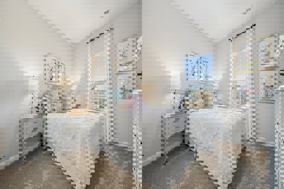 A bedroom with a bed and a window.