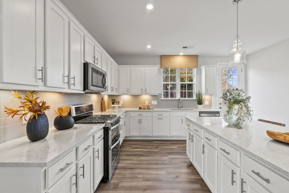 A kitchen with white cabinets.