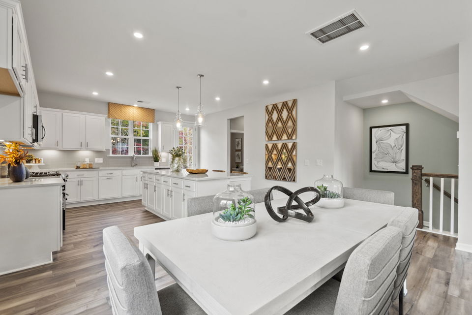 A kitchen with a dining table.