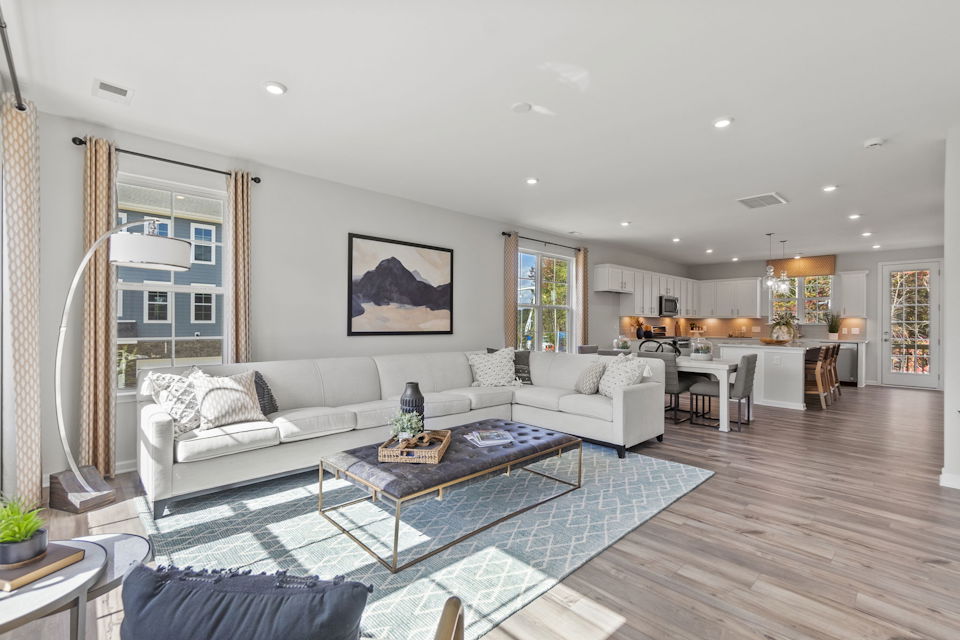 A large living room with a large glass coffee table.