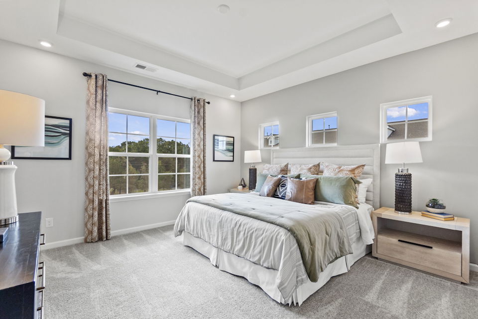 A bedroom with a large window.